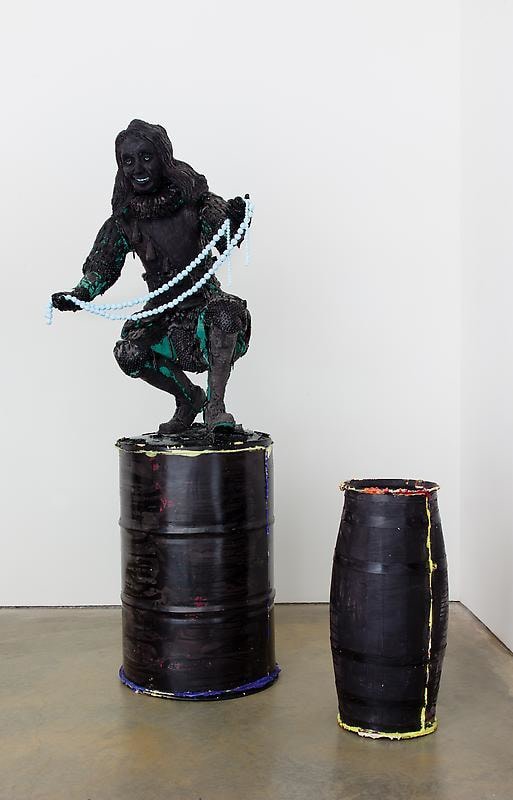 black figure on top of black barrels
