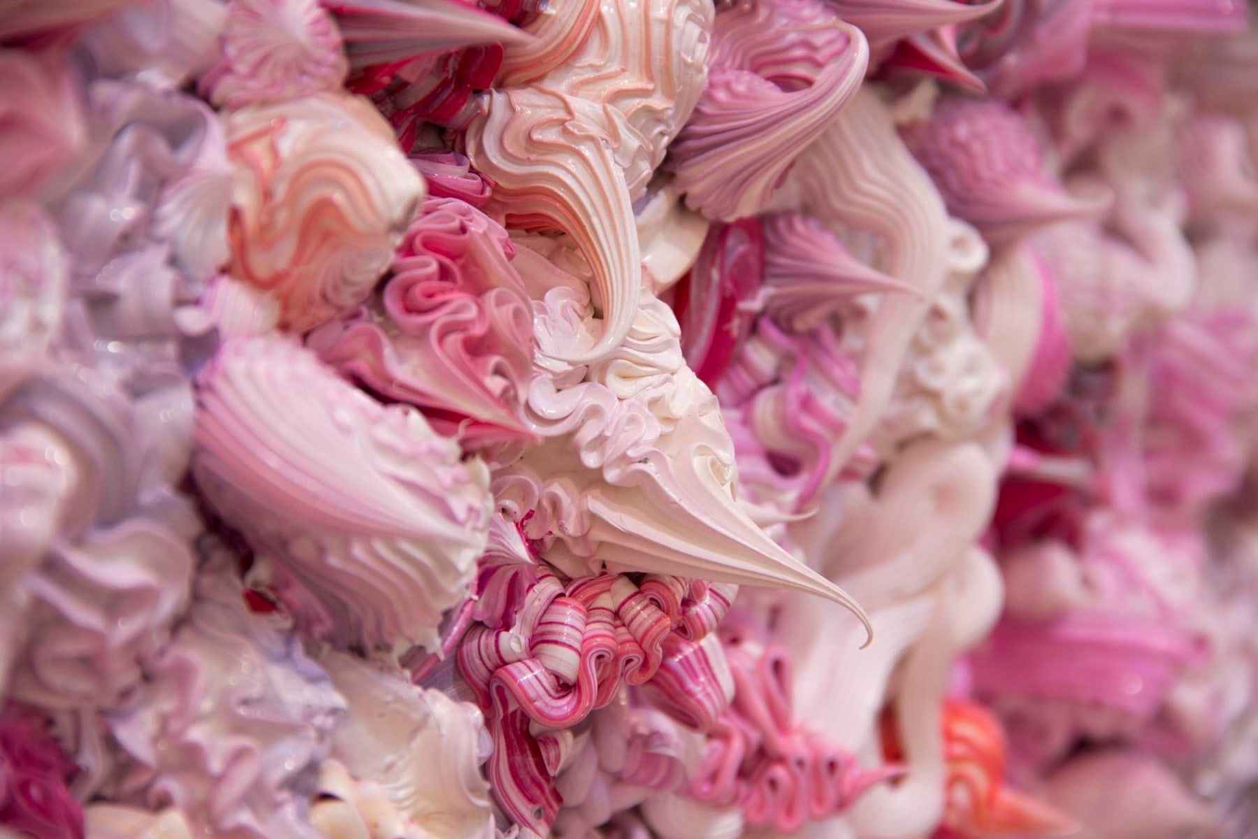 close up of whipped cream like substances in pink and purple hues