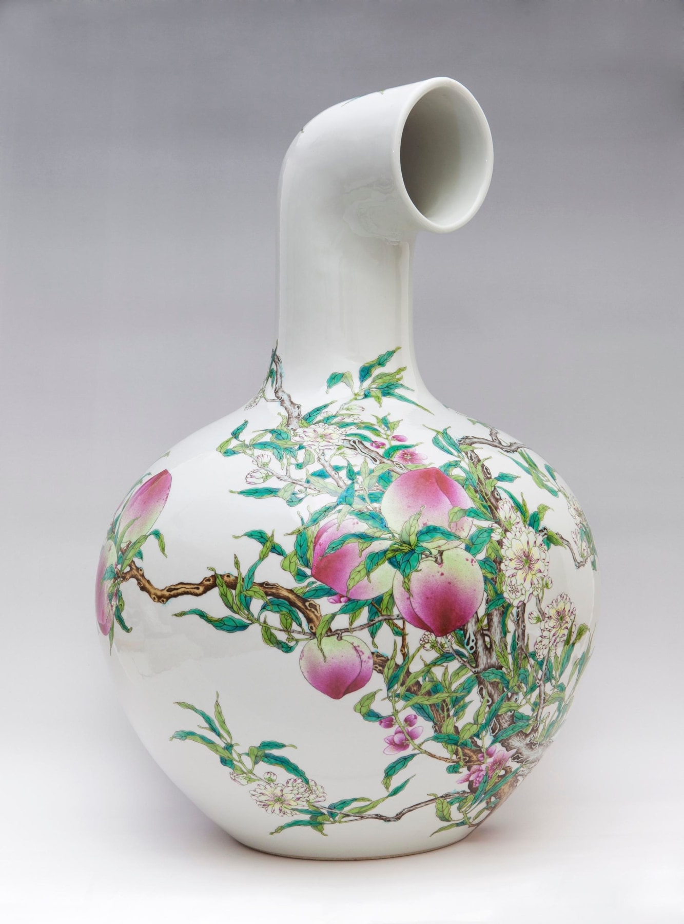 A white, long necked vase, with a peach tree painting on the body