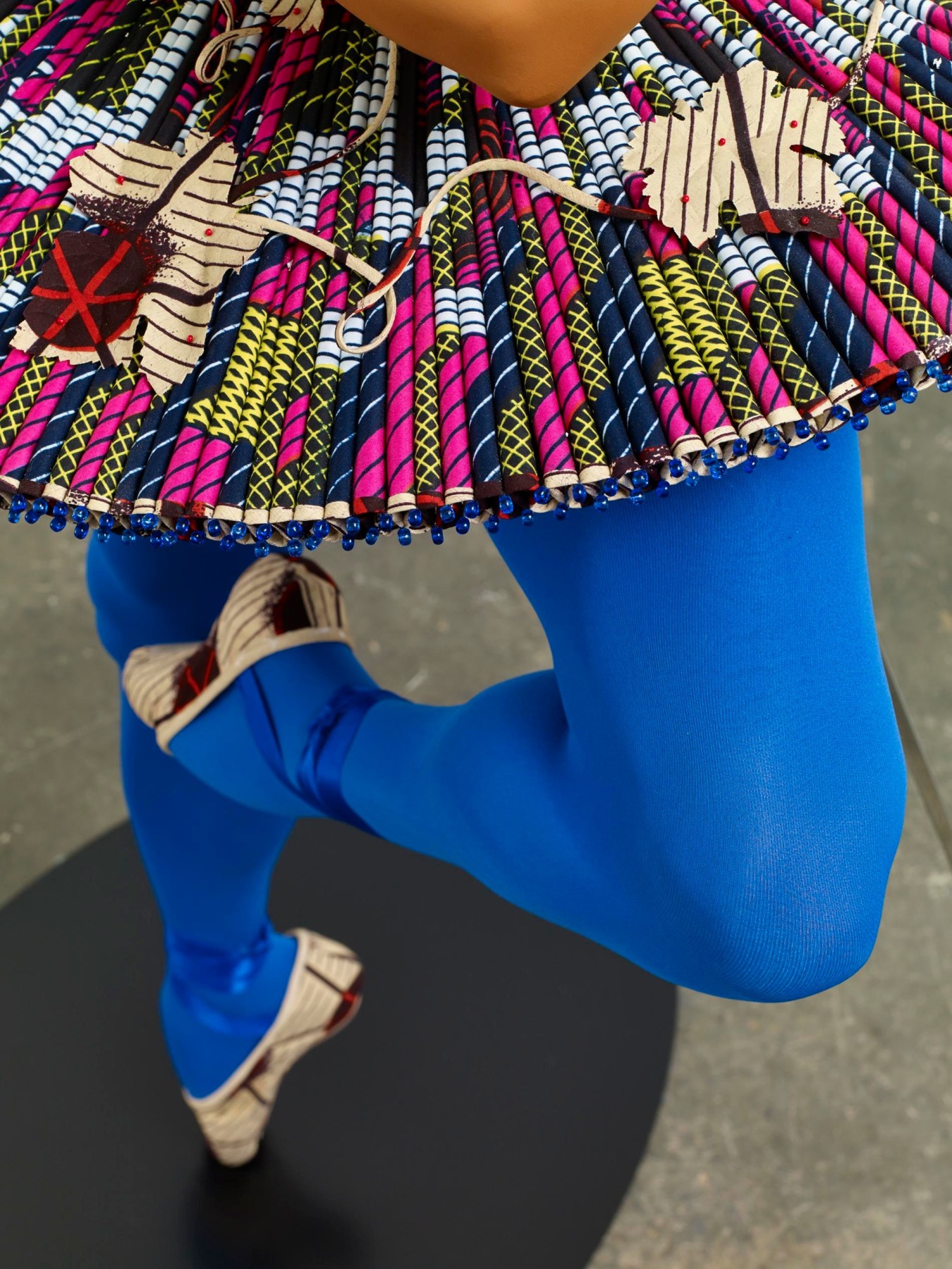 close up of mannequin's legs whilst dancing ballet; they are wearing blue tights
