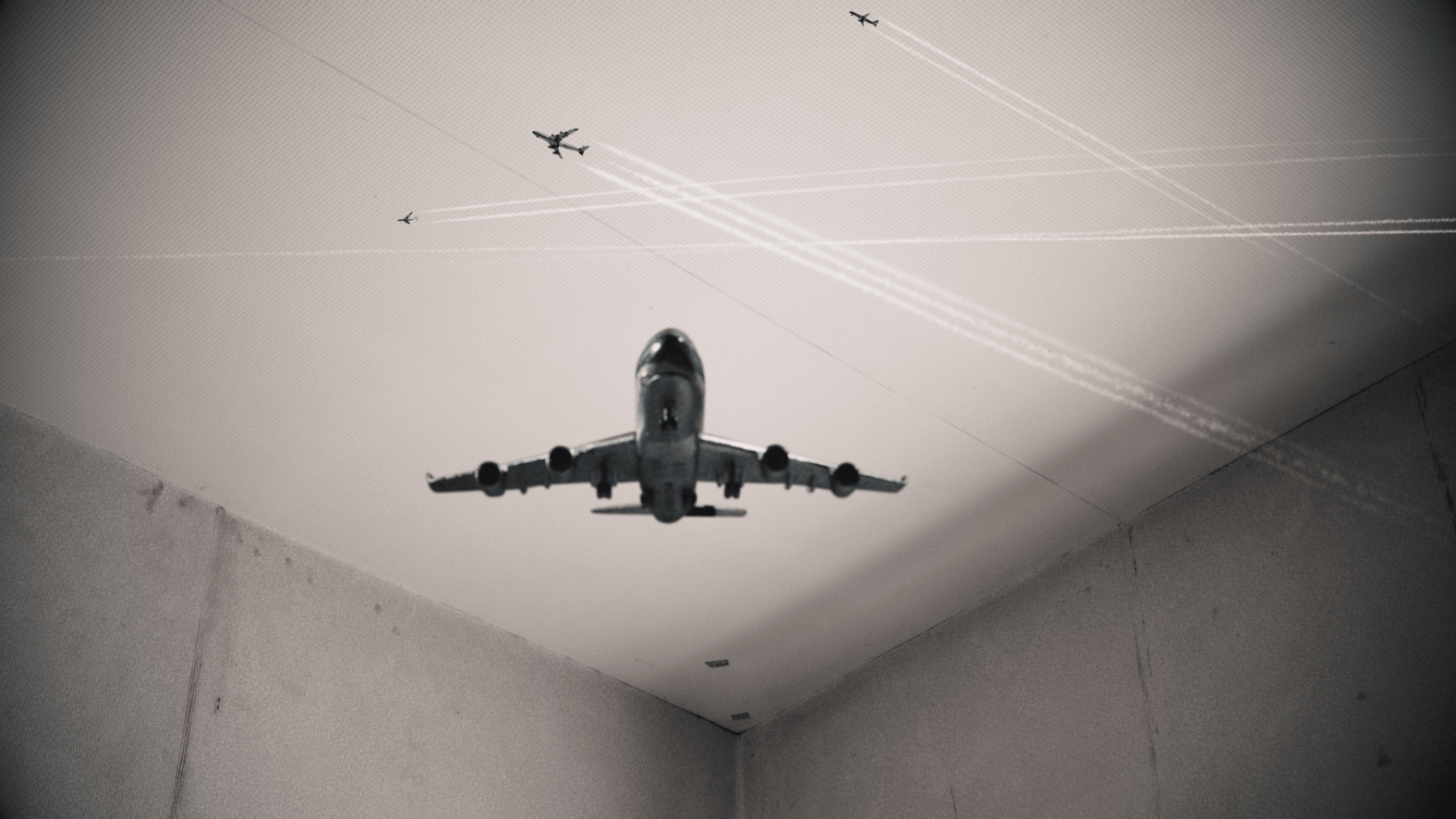 small airplanes are flying inside a concrete room, leaving behinds trails of smoke