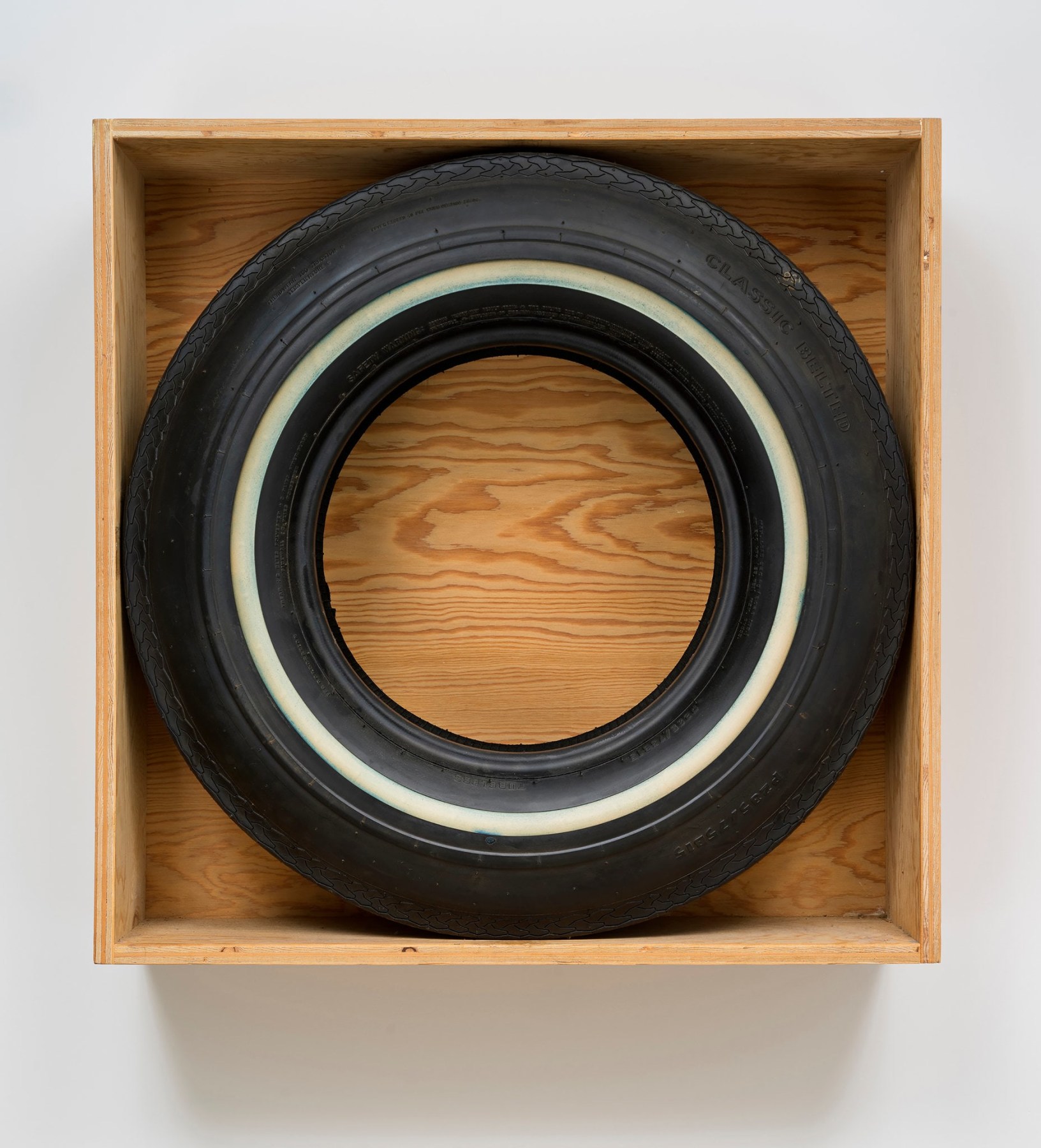 John Dogg&rsquo;s 1986 &ldquo;Untitled (Classic Belted),&rdquo; a round tire circumscribed by a square box. via Venus Over Manhattan