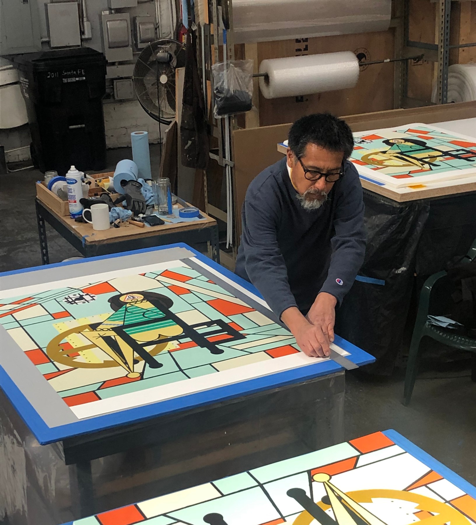 Lino Martinez cutting the prints.