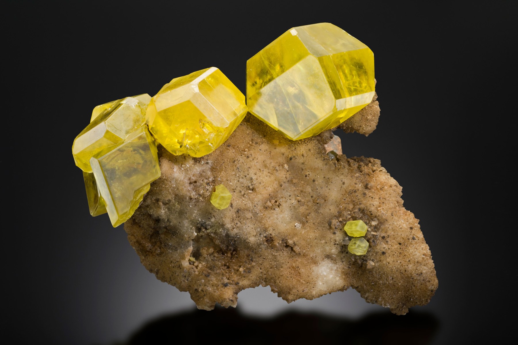 Sulphur on Aragonite with Bitumen, Sicily, Italy

This sulphur specimen is a beautiful example of its type, with excellent crystal form, translucency and lustre. Both the sulphur and aragonite are, however, quite common minerals, so are relegated in this view of the world to the fourth caste.