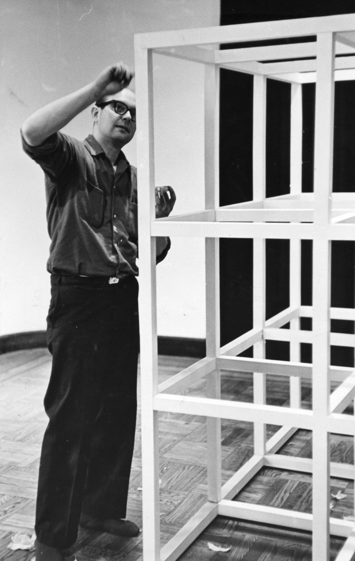 Sol LeWitt painting one his sculptures as he installs his work at the Primary Structures exhibition at the Jewish Museum, New York, 1966. Photo by Fred W. McDarrah / MUUS Collection via Getty Images.