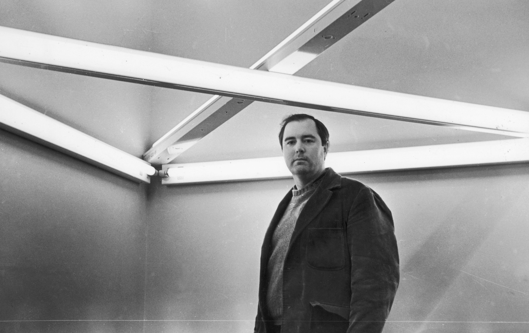 Dan Flavin with&amp;nbsp;monument 4 for those who have been killed in ambush (to P.K. who reminded me about death),&amp;nbsp;1966, at the&amp;nbsp;Primary Structures&amp;nbsp;exhibition at the Jewish Museum, New York, 1966.&amp;nbsp;
Photo by Fred W. McDarrah / MUUS Collection via Getty Images.