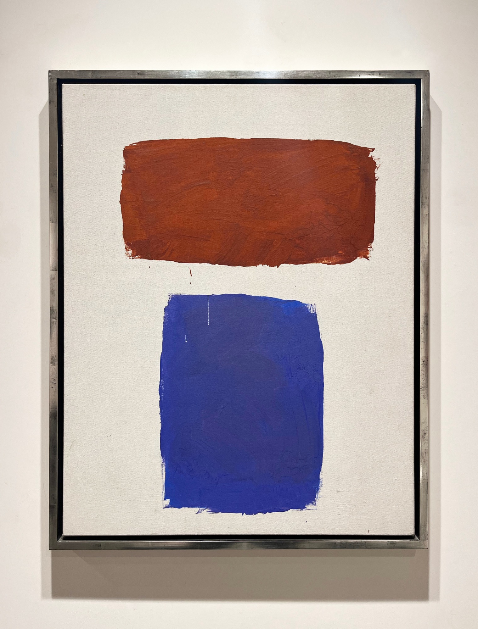 Abstract painting with brown and blue forms on a white ground