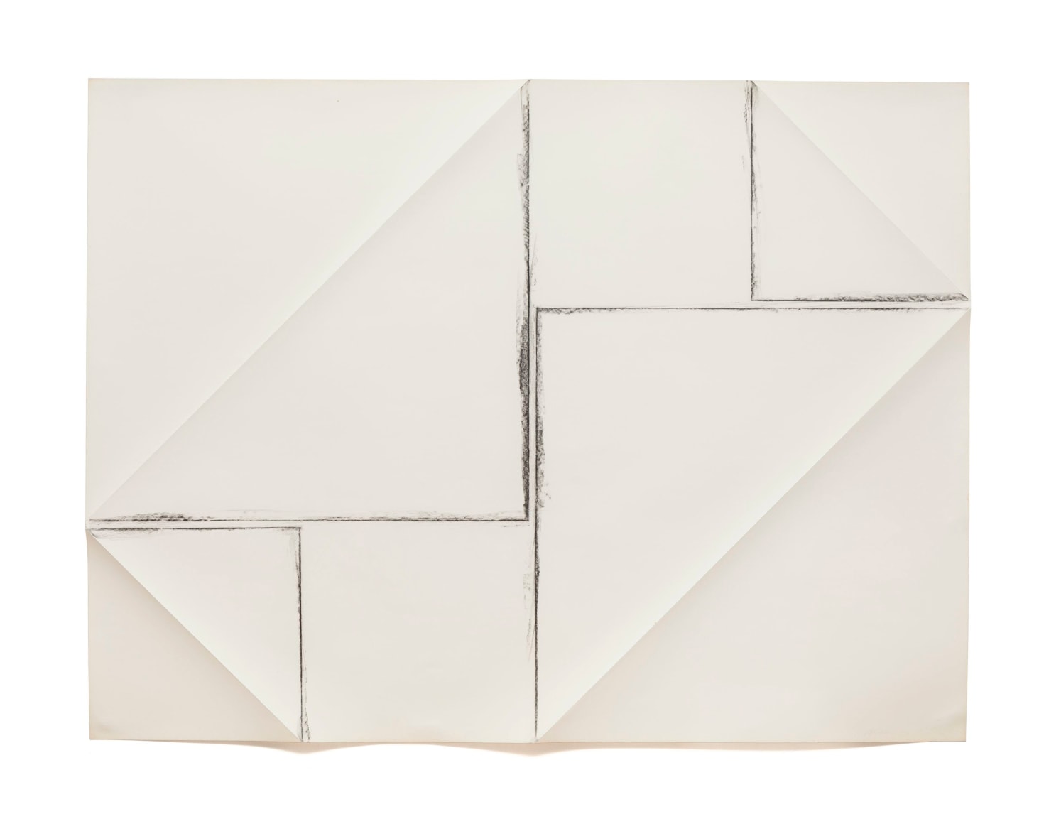 a piece of white paper which has been folded and rubbed with charcoal to show the folds