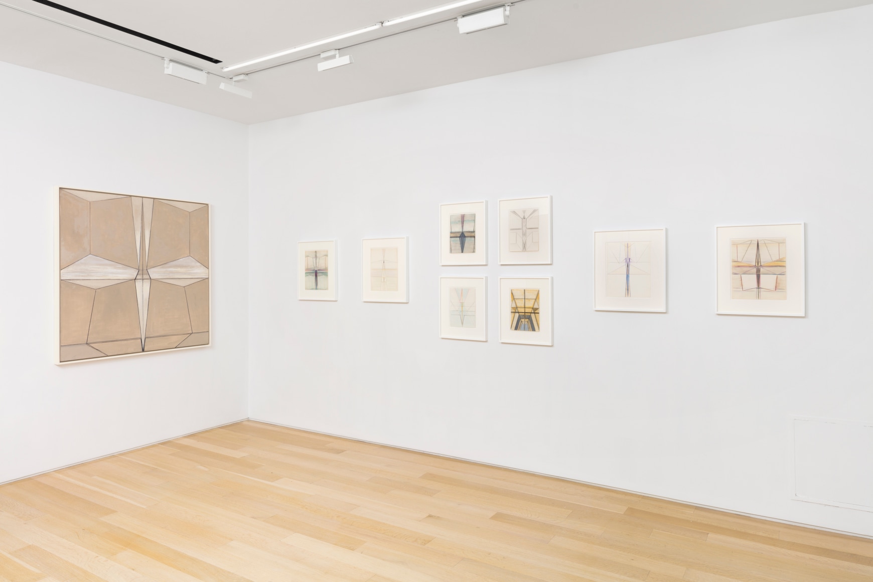 white gallery space with art on walls