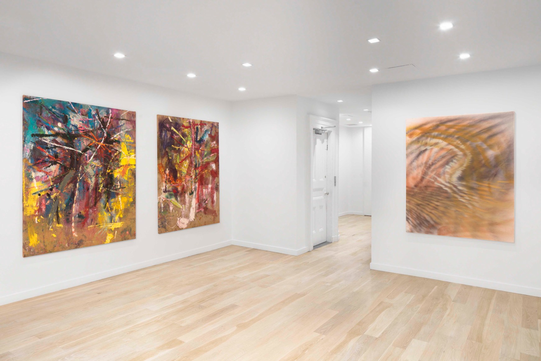 white gallery space with art on walls