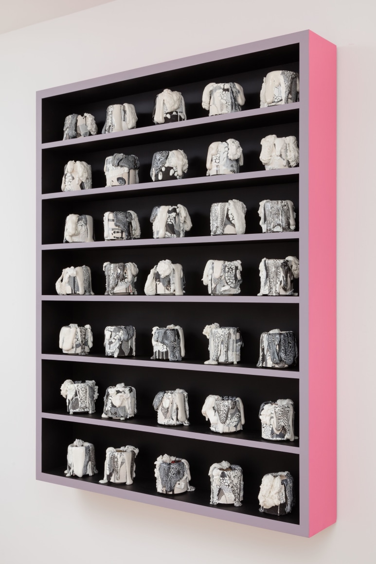 cabinet with a bunch of little ceramic pots in it