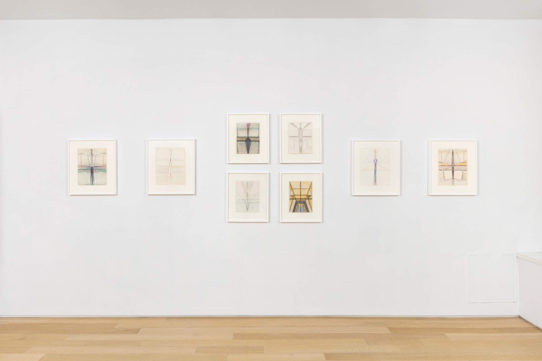 white gallery space with art on walls