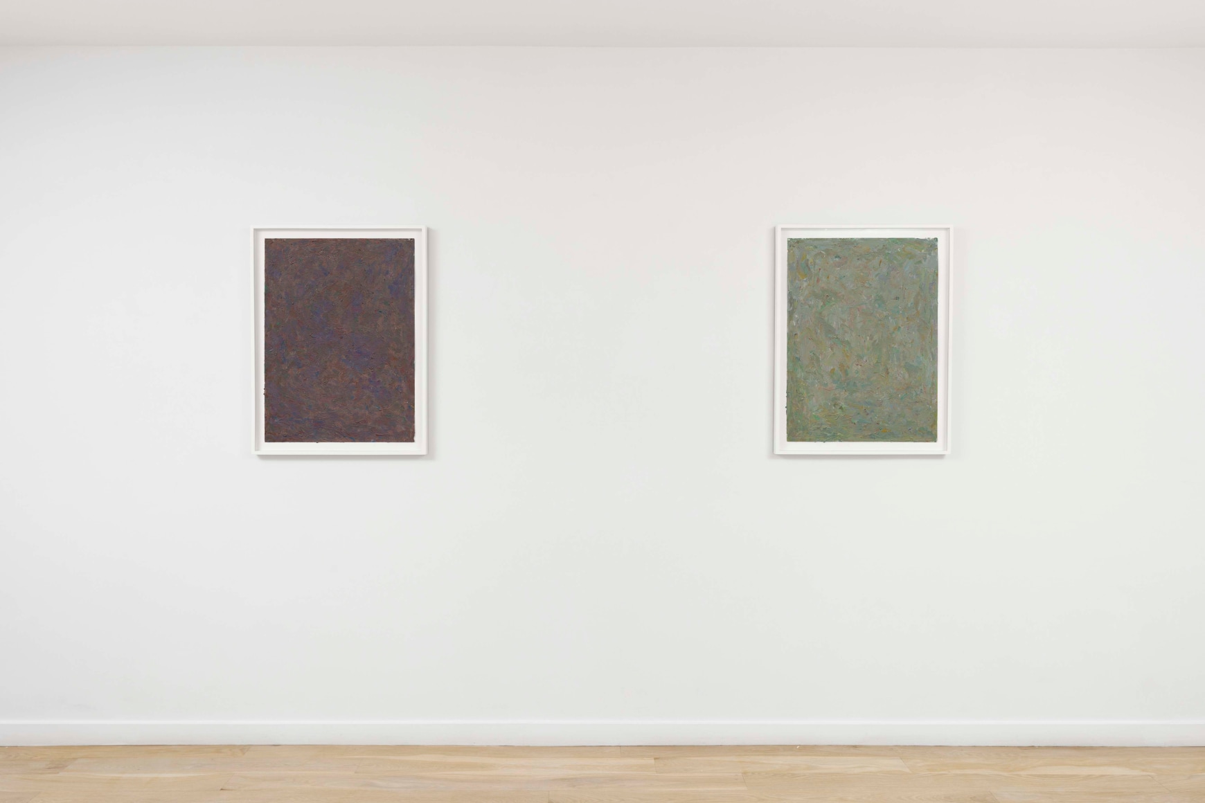 installation view of paintings in a white room