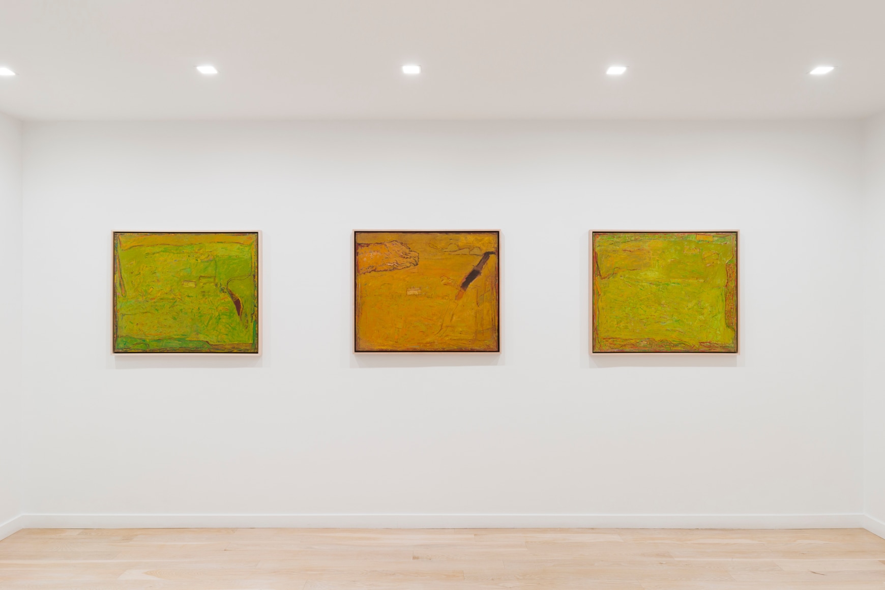 installation view of paintings in a white room
