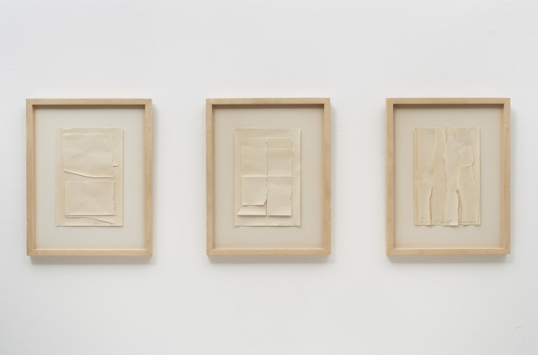 three framed works that are sheets of paper torn in various ways