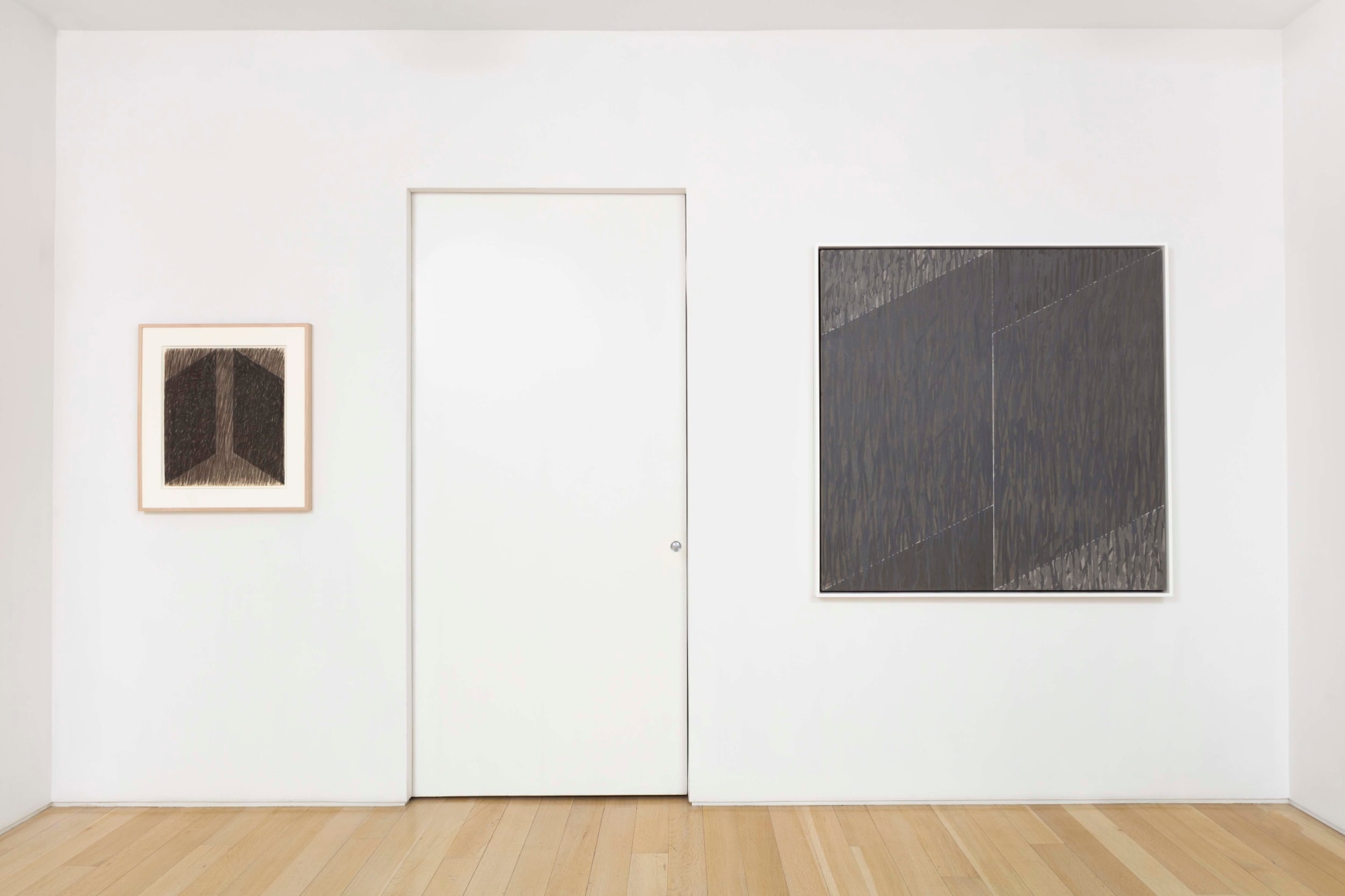 installation view of paintings in a white room