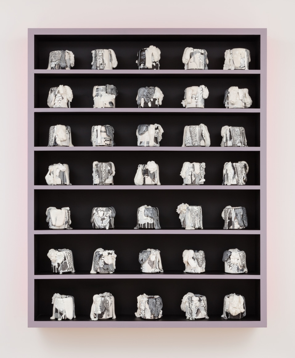 cabinet with a bunch of little ceramic pots in it