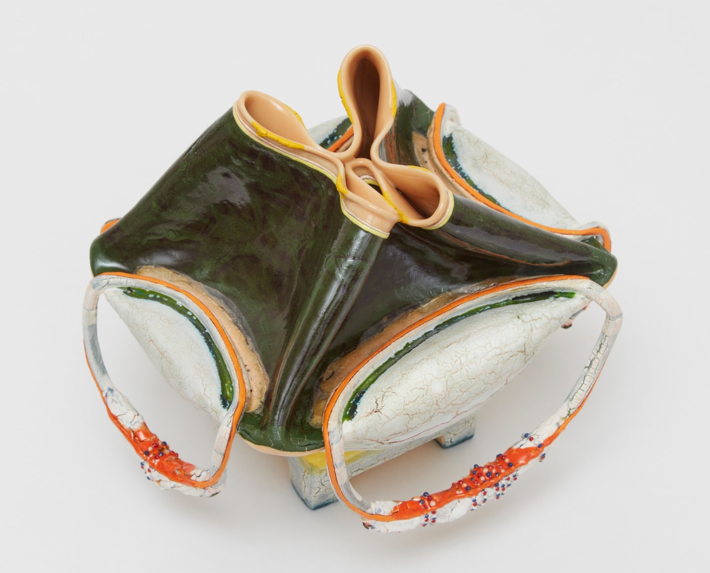 Predominantly green and white collapsed bag-like form