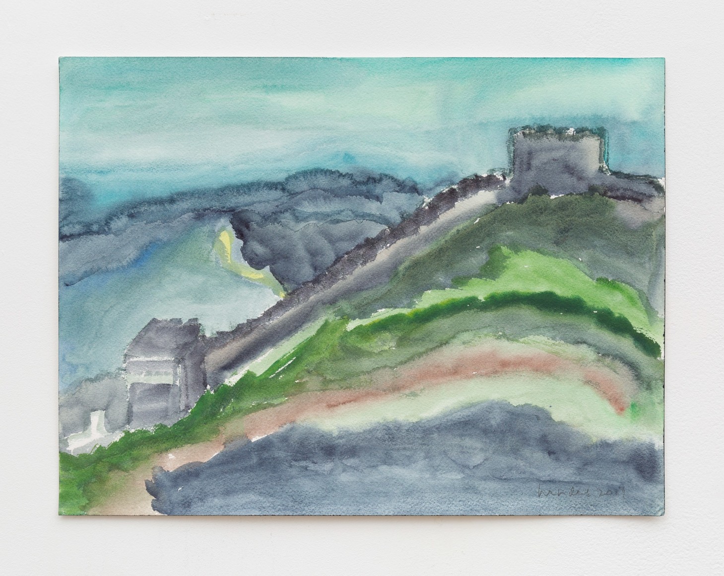 Fort wall on top of rolling hills with blue sky