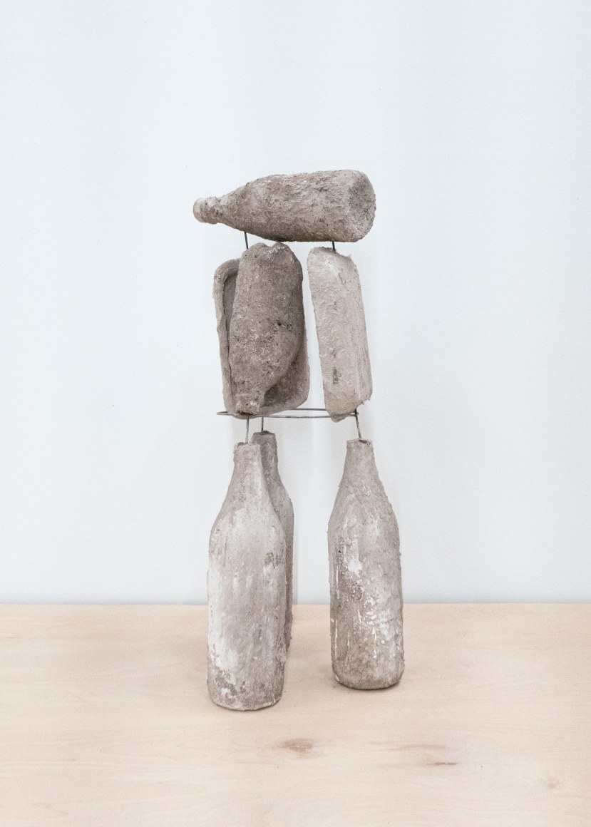 Erin Woodbrey  The Three Strange Sisters (From the Carrier Bag Series), 2022  Single-use plastic, glass, and foam containers, ash, plaster, gauze, and steel wire  63.50 x 27.94 x 22.86 cm / 25 x 11 x 9 in