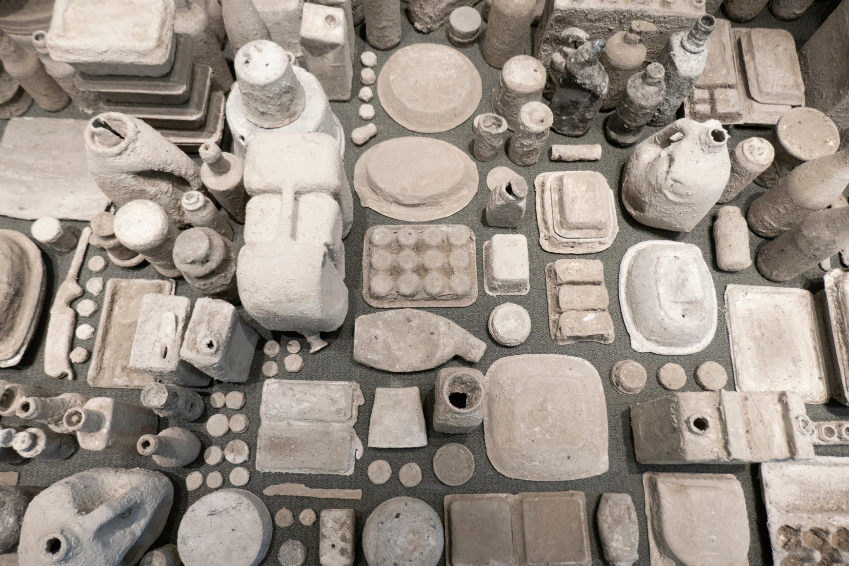 Erin Woodbrey  Cities in Dust (Corner Piece), 2022  Found objects encased in wood ash,&nbsp;plaster, and gauze  5.1 x 5.1 x 4.5 m / 17 ft x 17 ft x 15 ft  (Detail View)