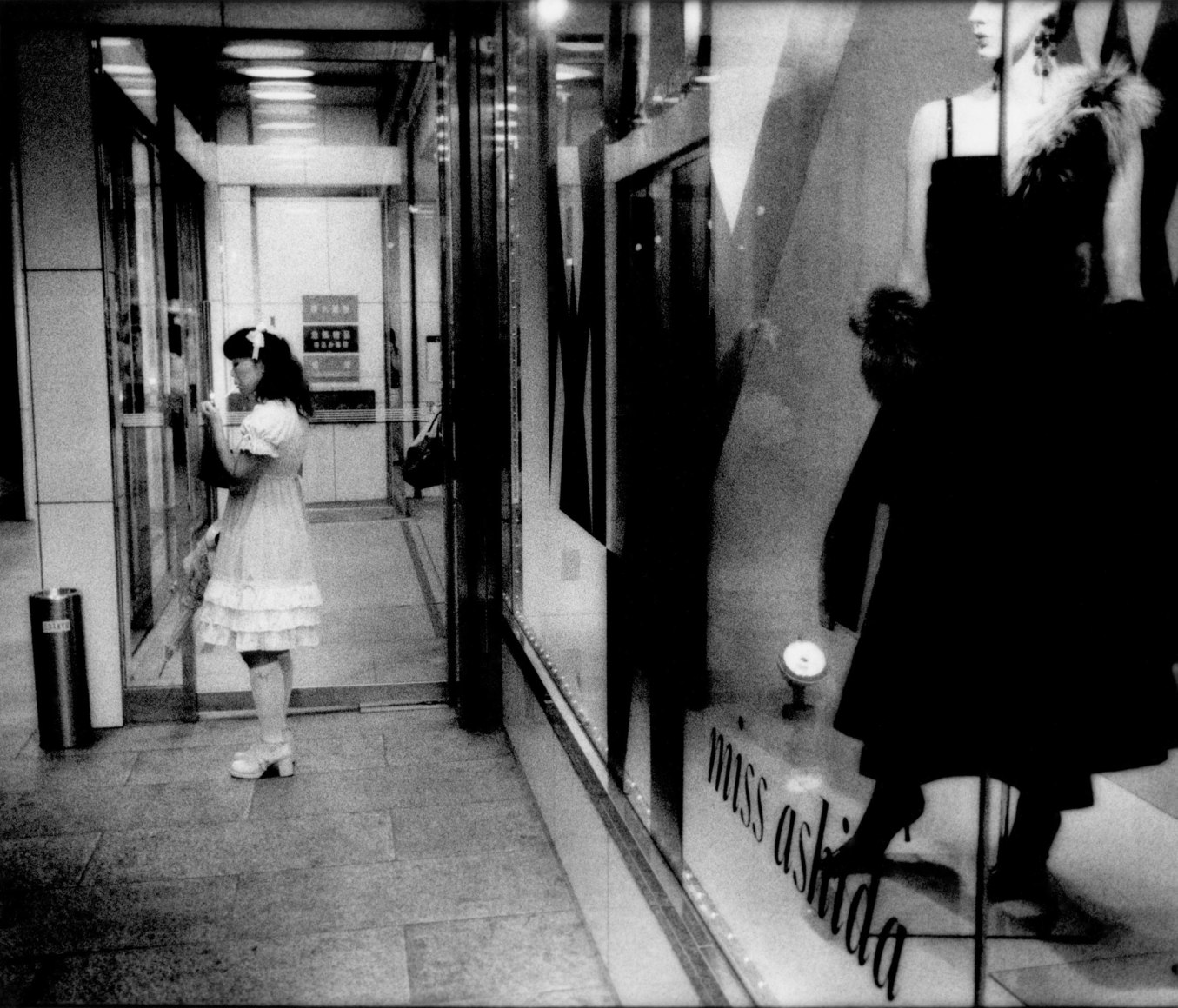 Woman in frilly dress lighting up, Tokyo, Japan, 2005 - Mangaland | James Whitlow Delano Documentary Photography