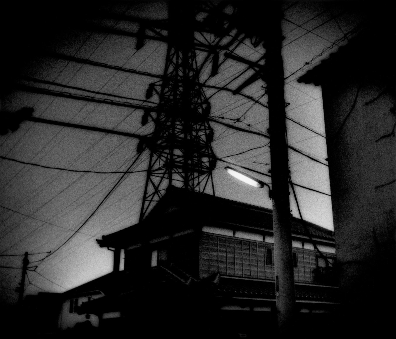 Traditional home beneath high power voltage lines, Seigo, Japan, 2004 - Mangaland | James Whitlow Delano Documentary Photography
