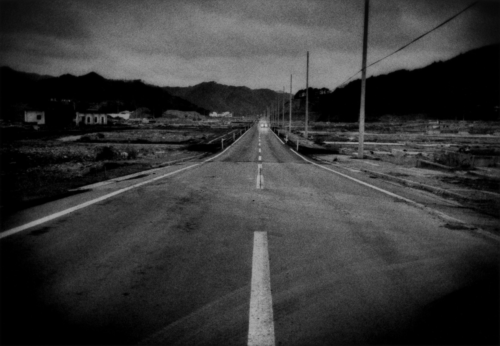 Twilight on a lonely highway through the ruins of the tsunami zone of Otsuchi, Iwate Prefecture, Japan, 2011