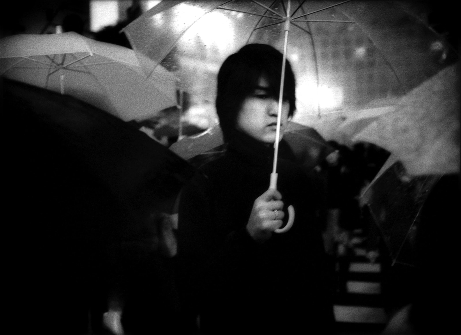 Under umbrella in nightime rain, Hachiko Shibuya, Tokyo, Japan, 2002 - Mangaland | James Whitlow Delano Documentary Photography