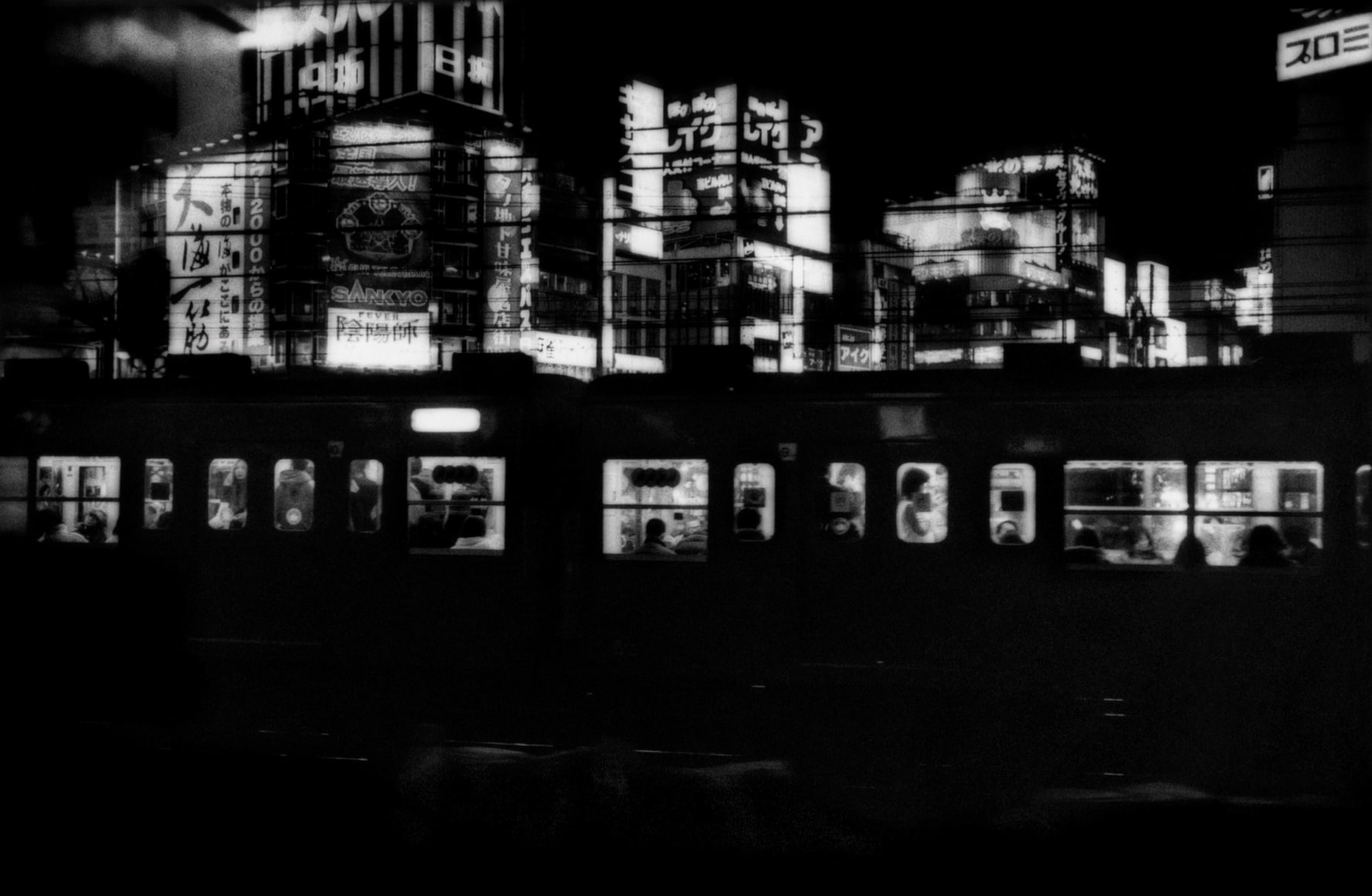 James Whitlow Delano, Mangaland, Chuo Line train coming into Shinjuko Station, Tokyo, Japan, 2005, Sous Les Etoiles Gallery