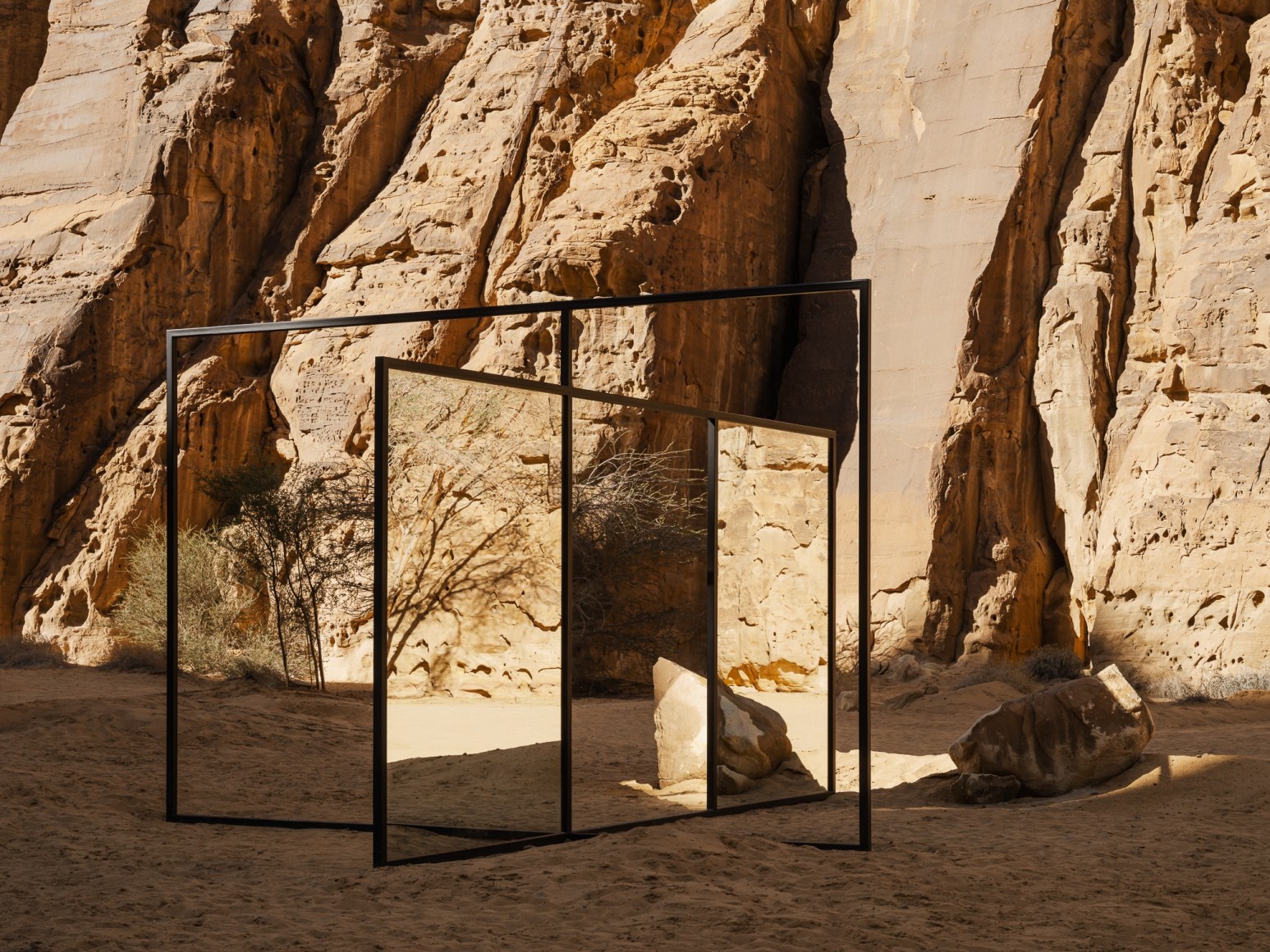 Alicja Kwade, In Blur, 2022, powdered coated steel, mirror, stones, trees and other natural elements. Installation view: Desert X AlUla, 2022. Photo by Lance Gerber. 