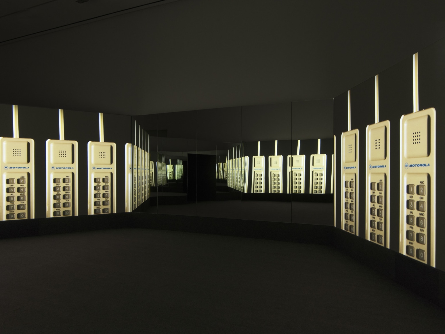 Doug Aitken&rsquo;s &ldquo;New Era,&rdquo; at 303 Gallery. The video, centering on the man who invented the mobile phone, occupies a hexagonal space that alternates wall-size mirrors and video screens.  Credit John Berens/303 Gallery