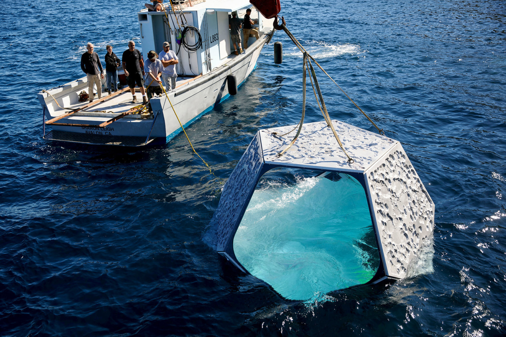 Crew members watching the lowering of one of Doug Aitken&rsquo;s &ldquo;pavilions&rdquo; into the Pacific for the artist&rsquo;s underwater art installation. Credit Patrick T. Fallon for The New York Times