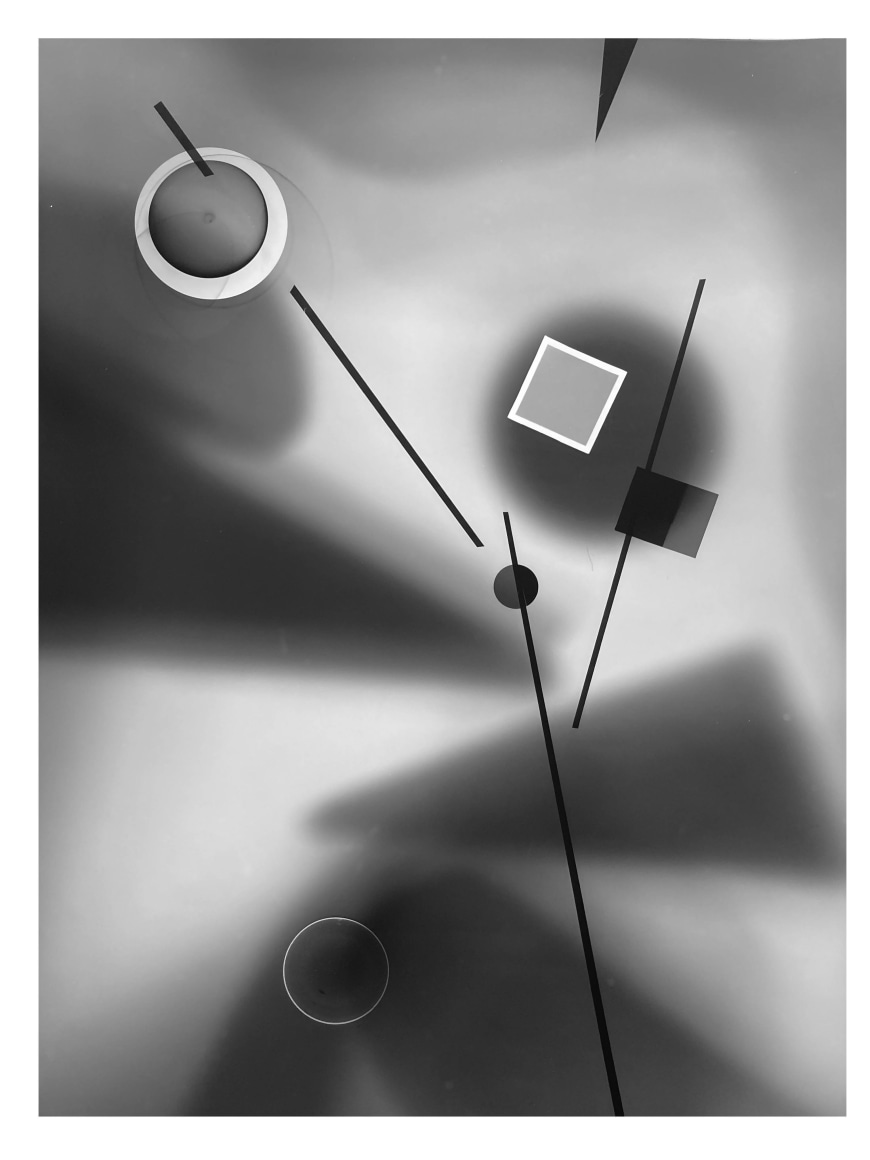 Black and white abstract photo print showing abstract composition made of brighter concentric circles and squares and darker lines.