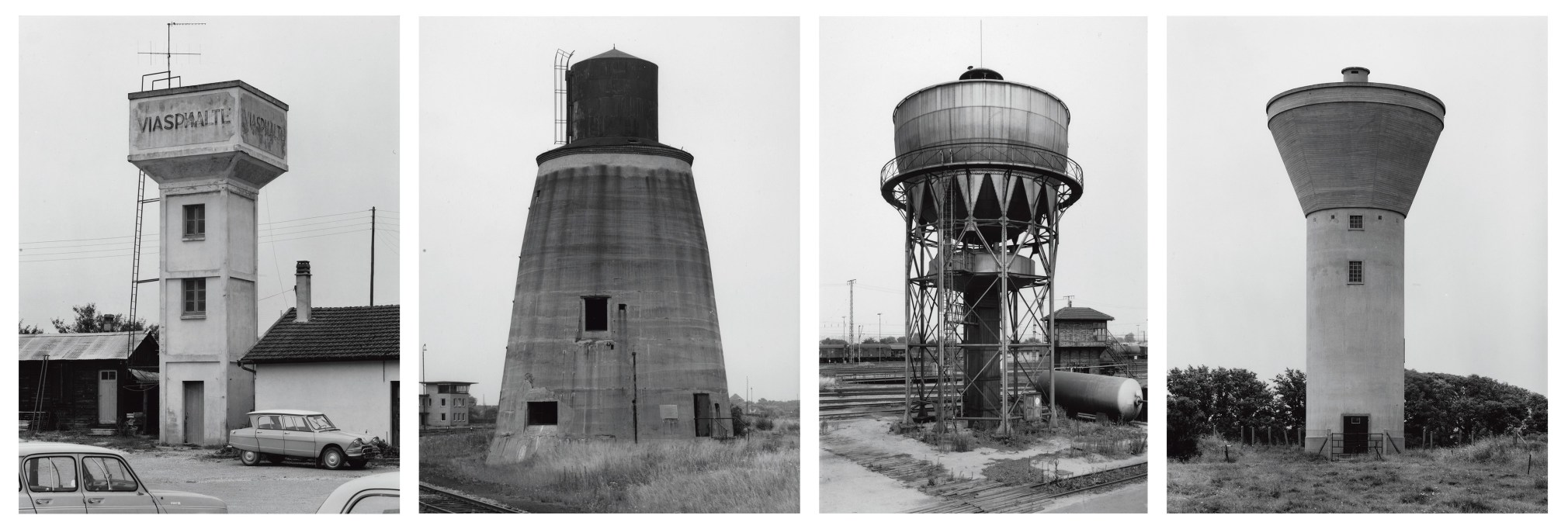 Four black and white photographs showing differing designs for early industrial water towers.