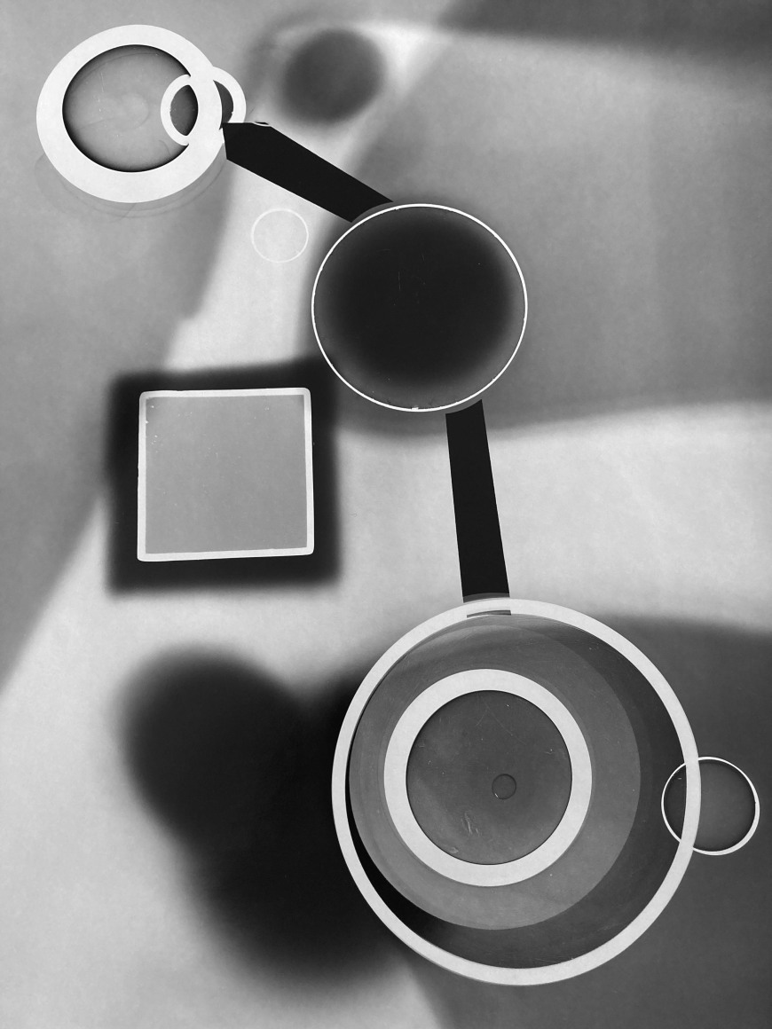 Black and white photographic abstraction showinga composition made up of concentric circles and squares.