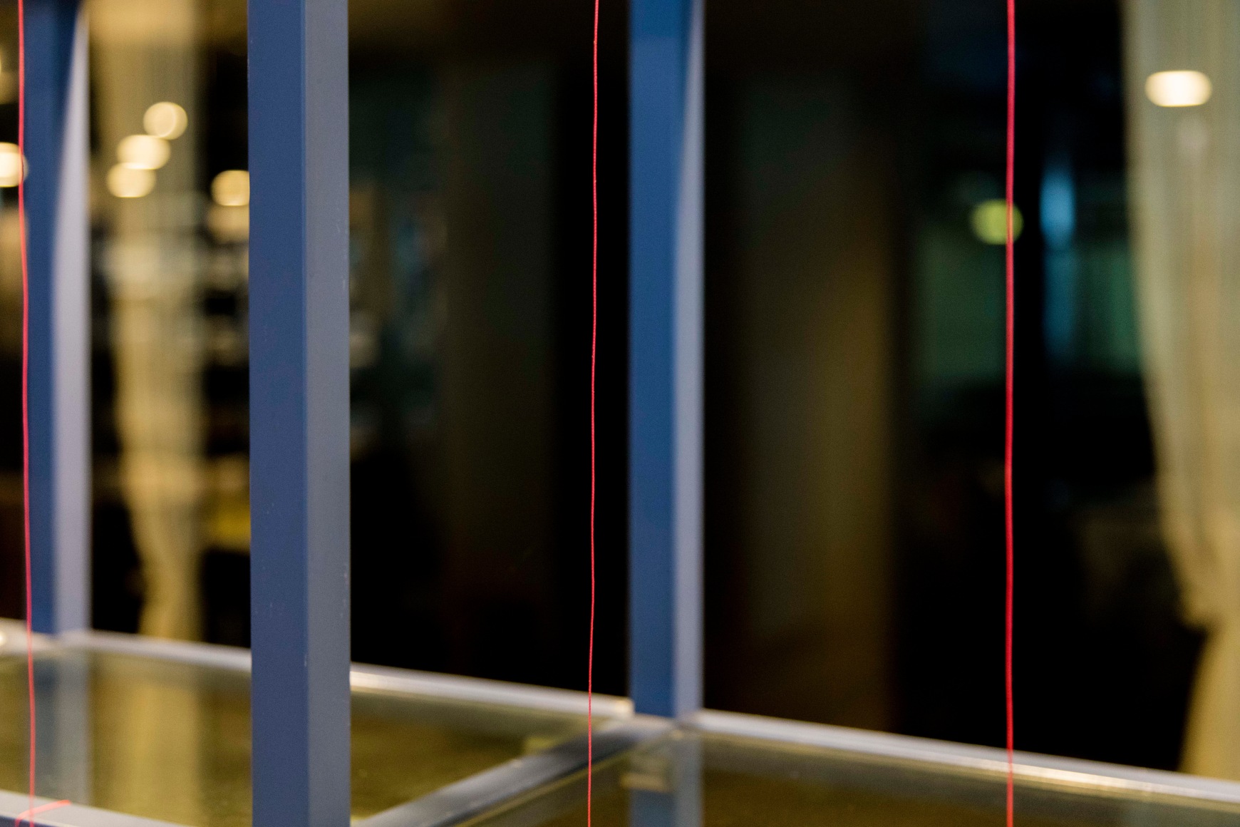 Color photograph showing colorful vertical architectural objects, charting an abstract composition.