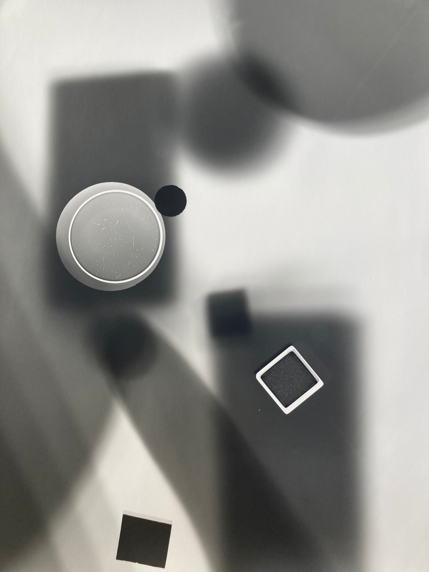 Black and white abstract photo print showing abstract composition made of brighter concentric circles and darker lines.