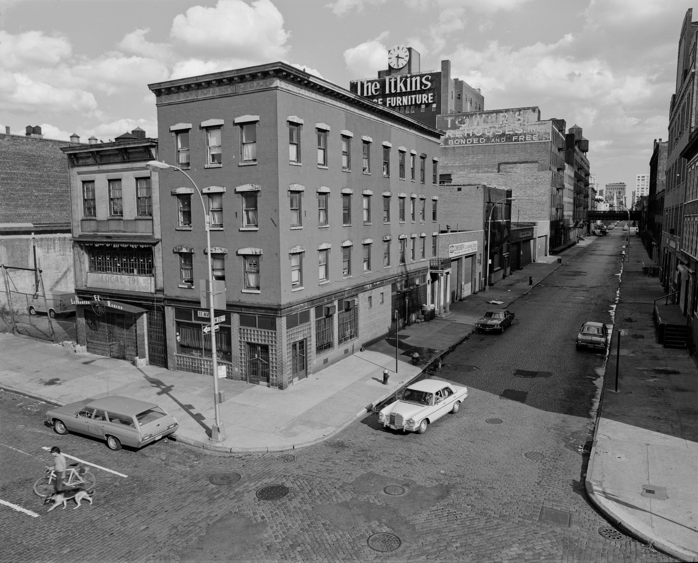 Black and white photo of a Manhattan street corner in the 1970s, shot from above.