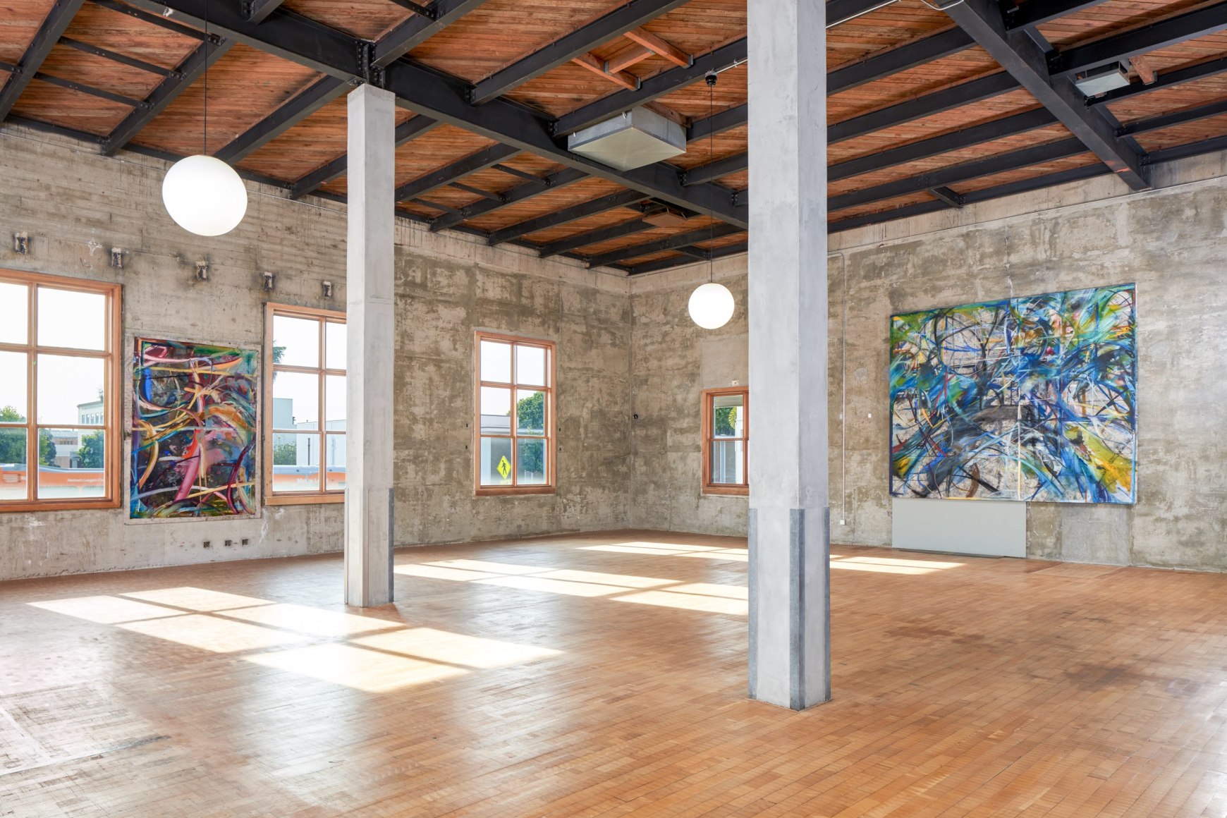 Installation view of Mariana Oushiro Paintings in a post office