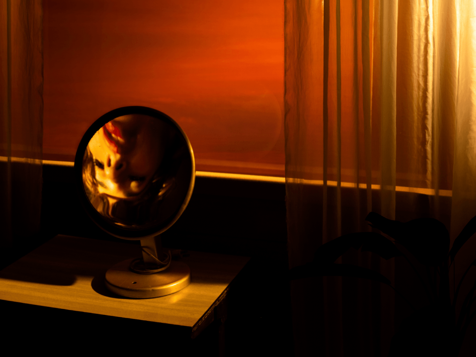 Tania Franco Klein, Rounded Mirror, Window (Self-portrait), 2022, from the series Break in Case of Emergency. Archival pigment print.