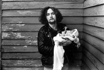 Man Holding Baby with Clenched Fist, 1986, 14 x 11 inches, gelatin silver print