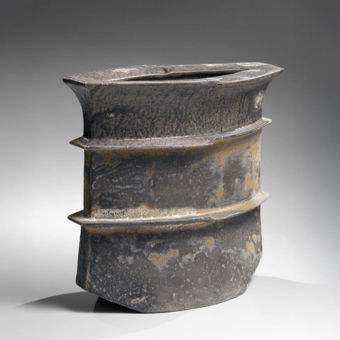 Flattened, ridged jar form with uplifted bottom corners and large rimmed mouth