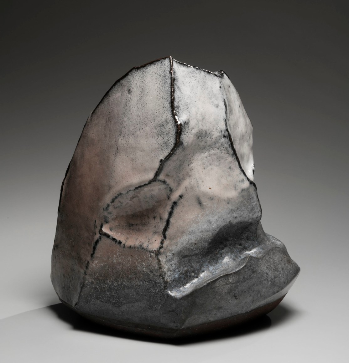 Kaneta Masanao (b. 1953), Rock-like vase with multi-plane body, Hagi glaze and extensive kiln effects in pinks and greys