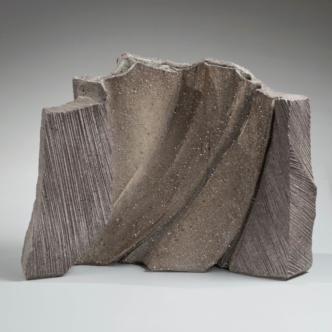 Curvilinear vessel with silver glaze and file-impressed exterior, Stoneware with silver glazes