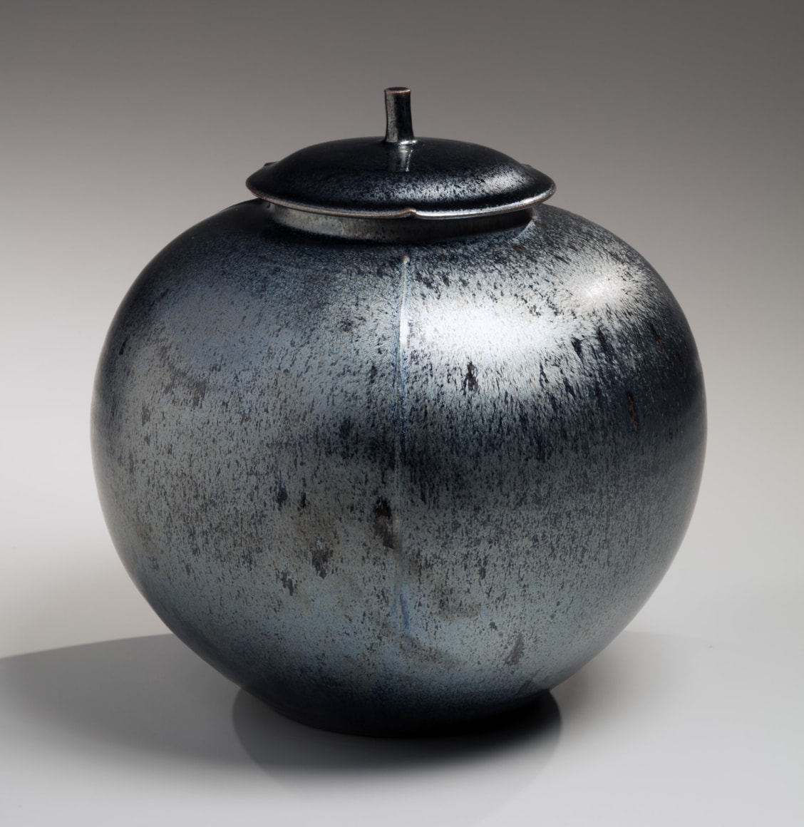 Silver tenmoku large cover jar with matching foliated cover with short cylindrical knob, 2017
