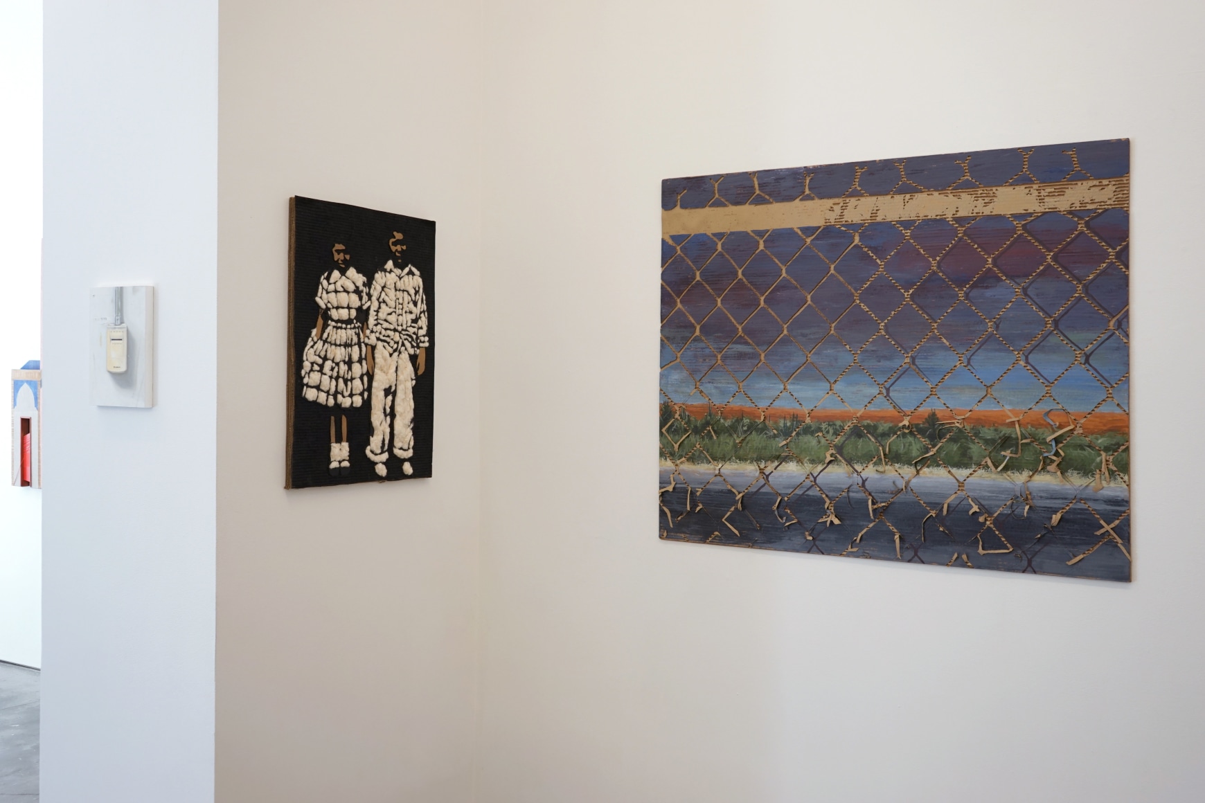 This is an installation view of the group exhibition Counter Narratives: Geographies of the Unfamiliar, which features paintings on the walls.