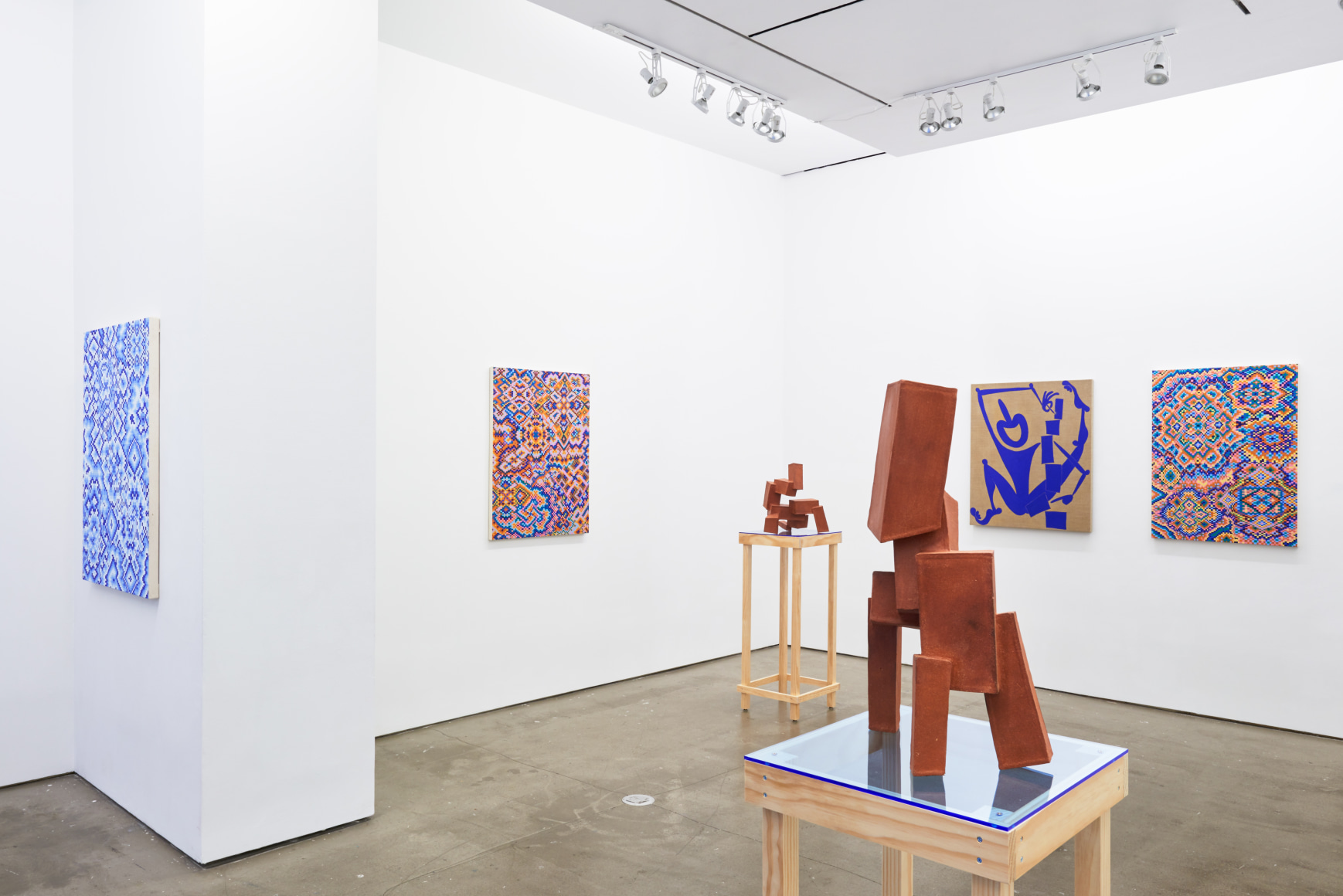 Installation view of works by Todd Kelly. Paintings and sculptures are next to each other.