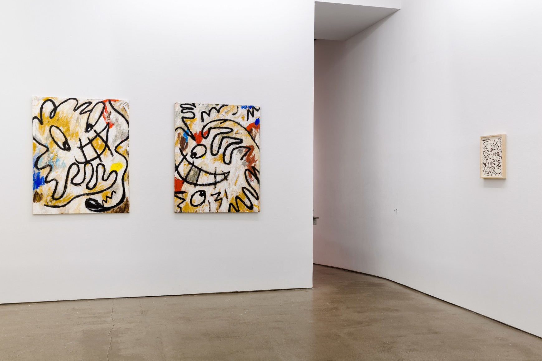 Installation view from Ricardo Gonzalez's solo exhibition. Featuring paintings and framed drawings on the wall by a doorway