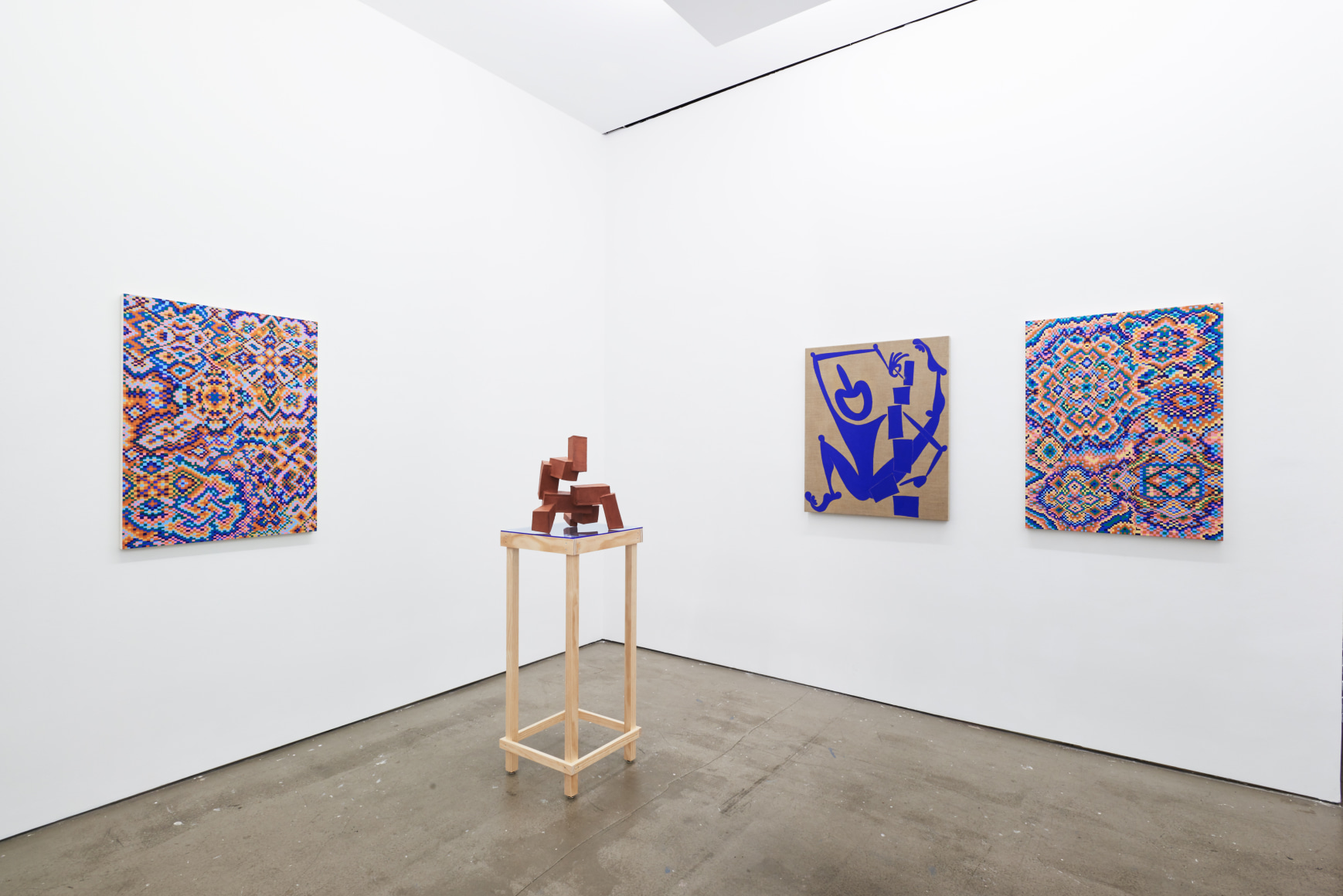 Installation view of works by Todd Kelly. Paintings and sculptures are next to each other.
